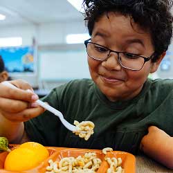student eating pasta