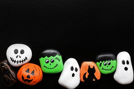 A,Row,Of,Spooky,Cartoon,Halloween,Painted,Rocks,Are,Lined