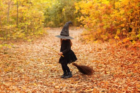Cute,Happy,Little,Redhaired,Girl,Dressed,In,Witch,Costume,Sitting